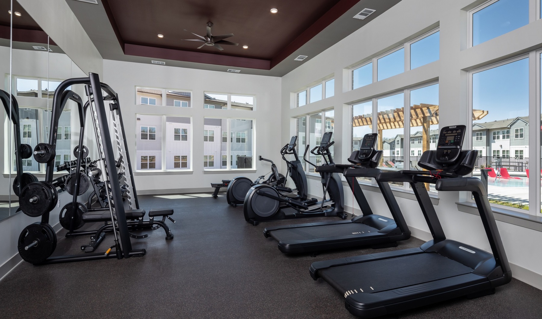 Fitness Center The fitness center at our apartments in Jefferson, featuring treadmills, weight machines, and a view of the apartments
