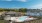 Aerial photograph of the pool area at our apartments in Jefferson, featuring umbrellas and a clubhouse. 